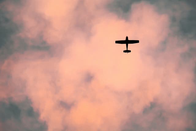 A small airplane flies in the sky